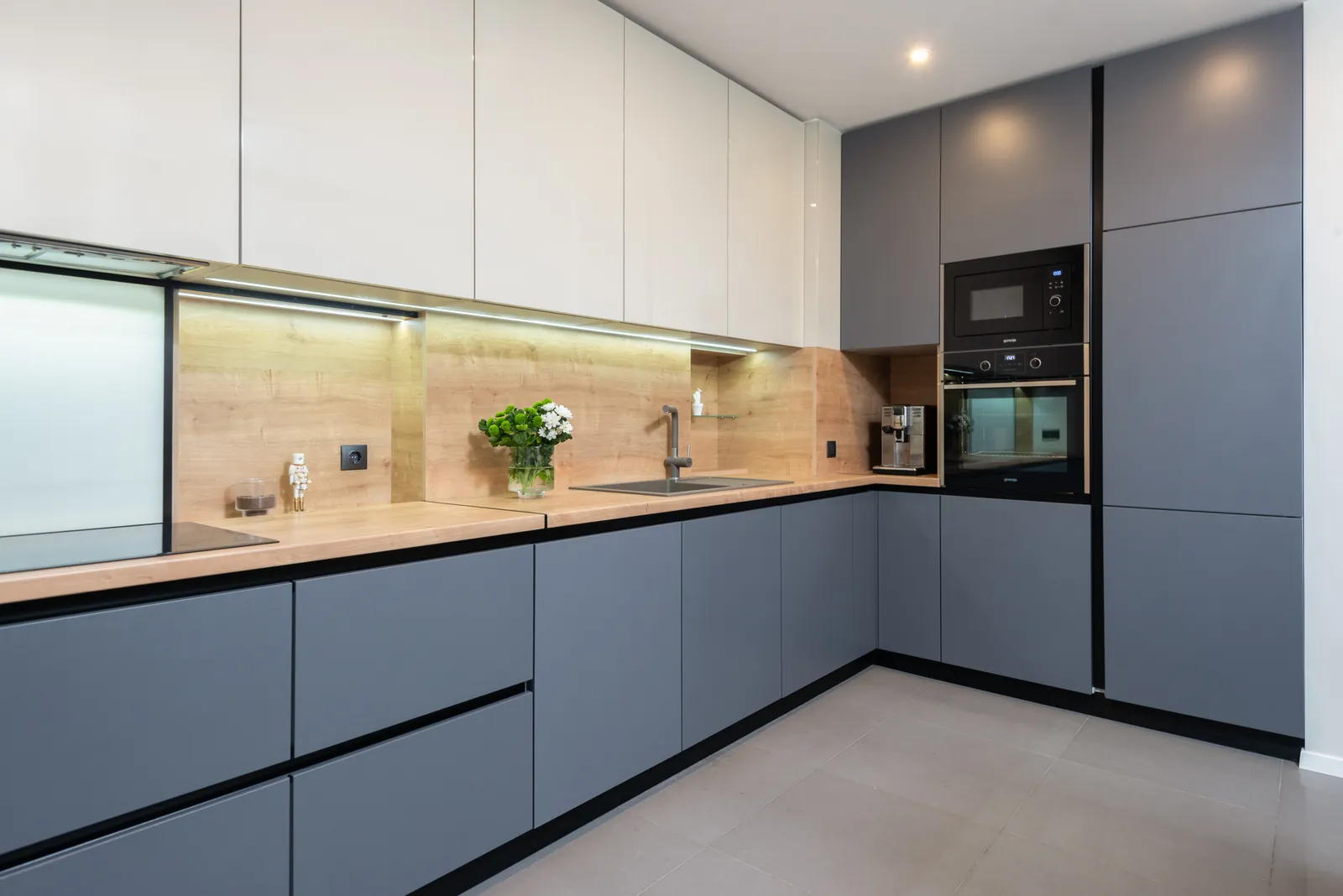 Top modern handleless modular kitchen design in grey and white with built-in oven Rajkot